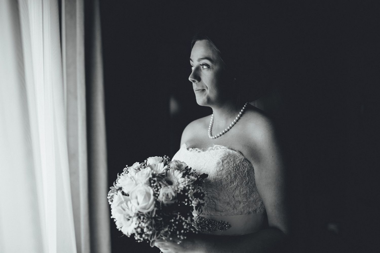 Elegant black and white photos of bridal details featuring flowers and lace dress.