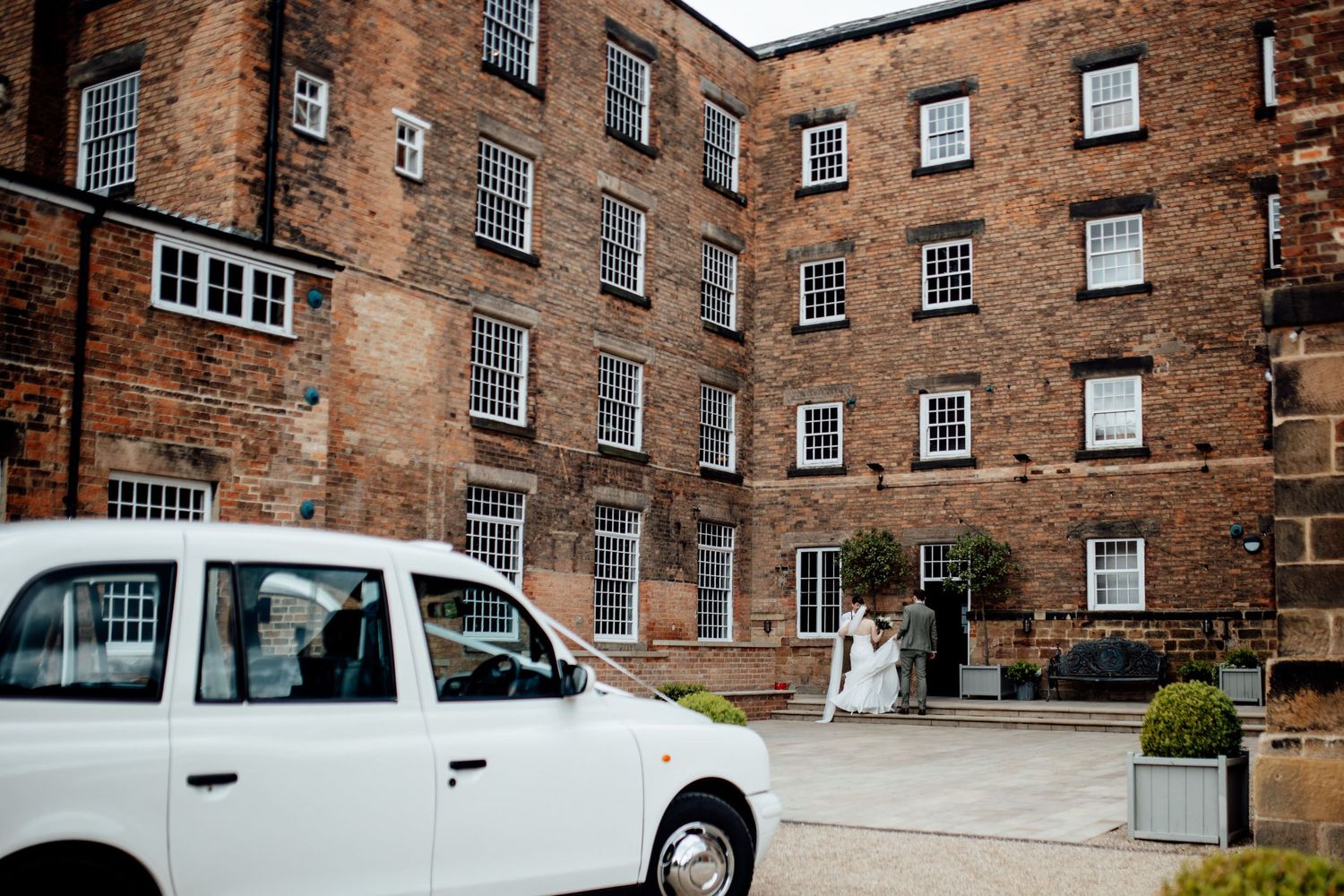 Historic brick building exterior with classic Georgian architecture and white trim windows.