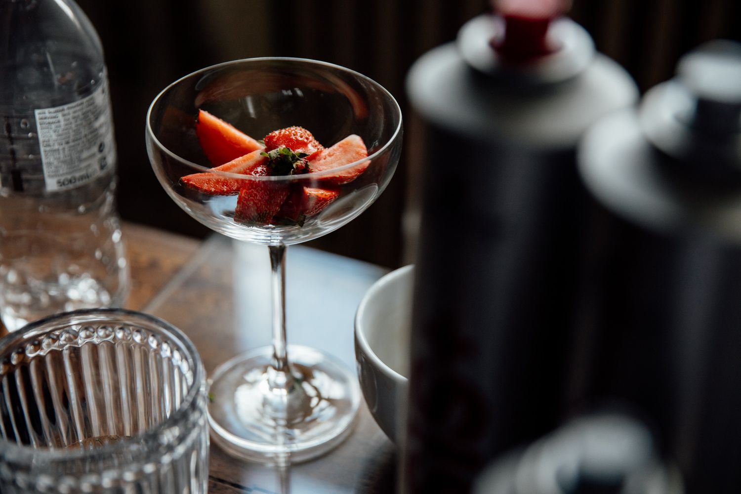 Elegant cocktail glasses with garnished drinks at an upscale wedding reception.