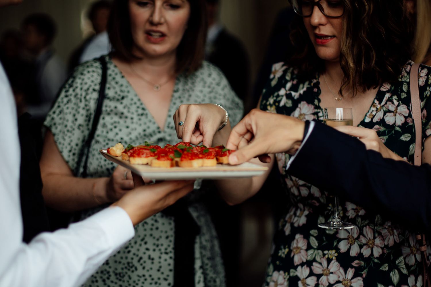 Guests enjoying food and drinks at an intimate wedding reception.
