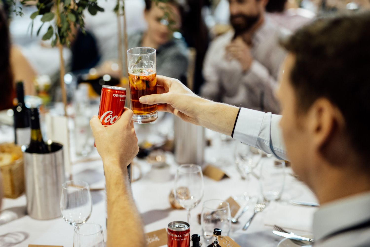 Table settings and drinks at an elegant wedding reception.