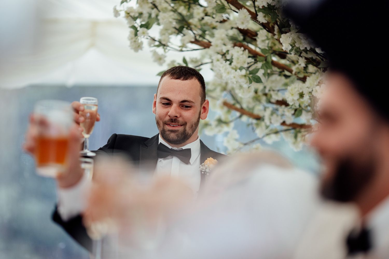 Wedding reception detail shot with white floral decorations and glassware.