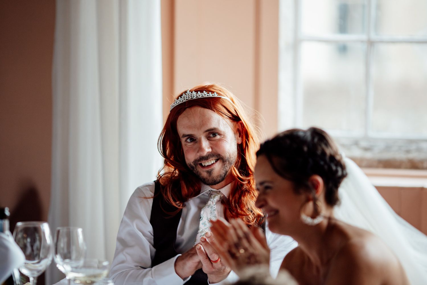 Emotional reactions during wedding reception speeches indoors.