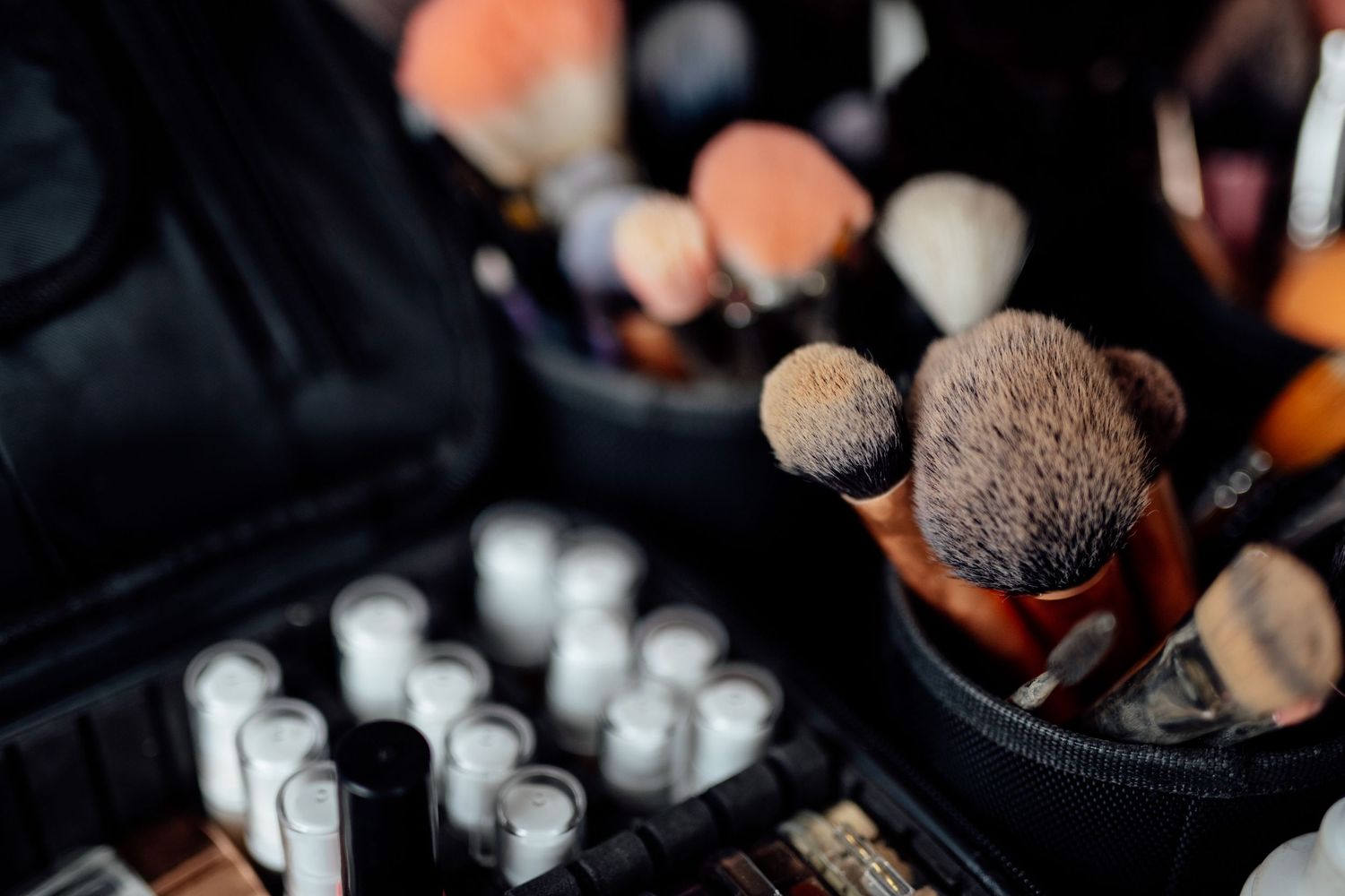Close-up detail shot of wedding makeup brushes and accessories.