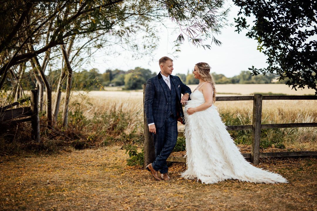 Artistic wedding photography series showing couple in natural outdoor settings with wooden fencing.