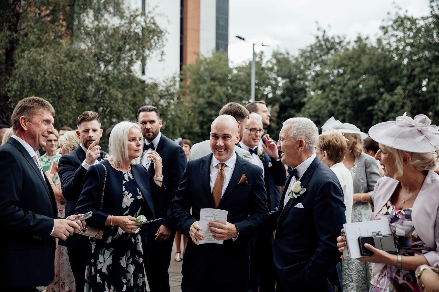 Wedding guests mingle during an outdoor cocktail hour.