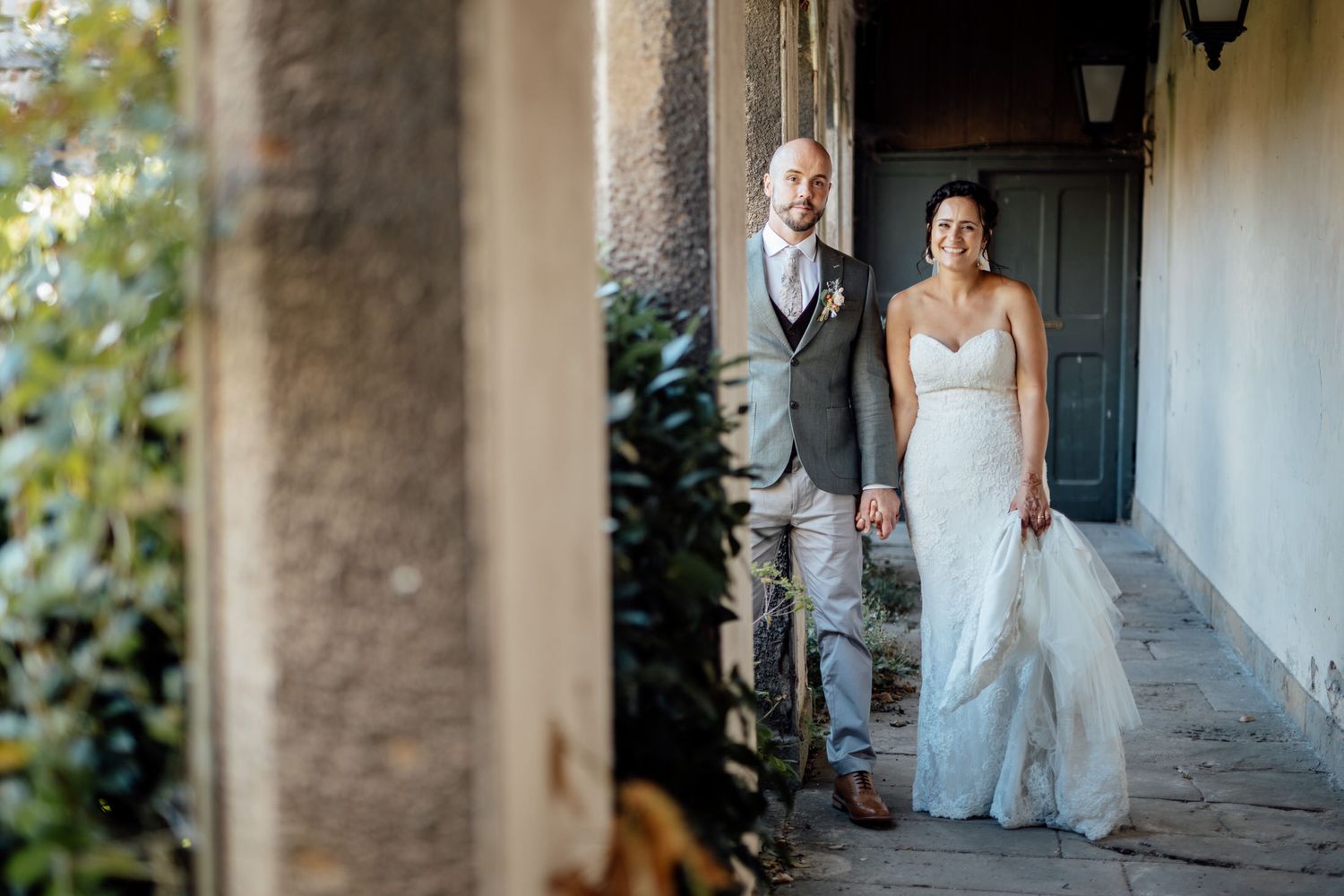 A beautiful stone archway corridor with natural light streaming in.