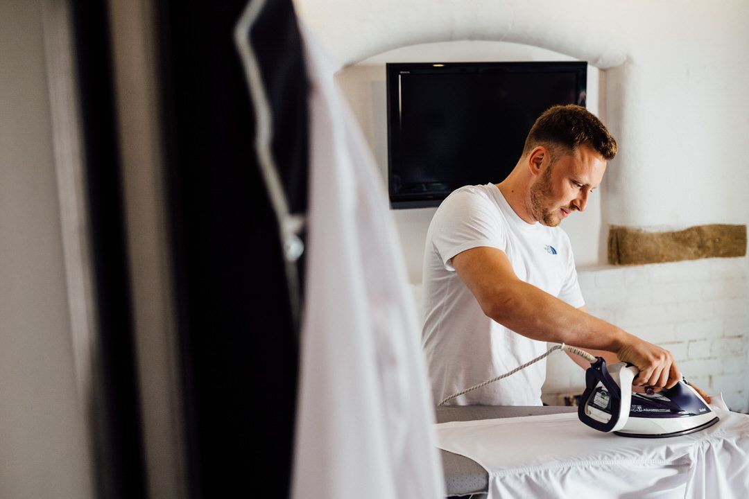 Wedding preparation scene with white decor and natural lighting in a modern interior.