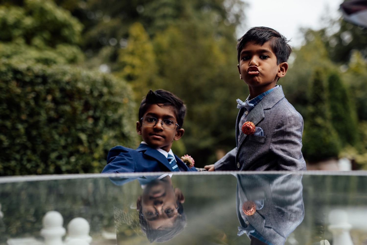 Children playing outdoors during wedding festivities in casual attire.