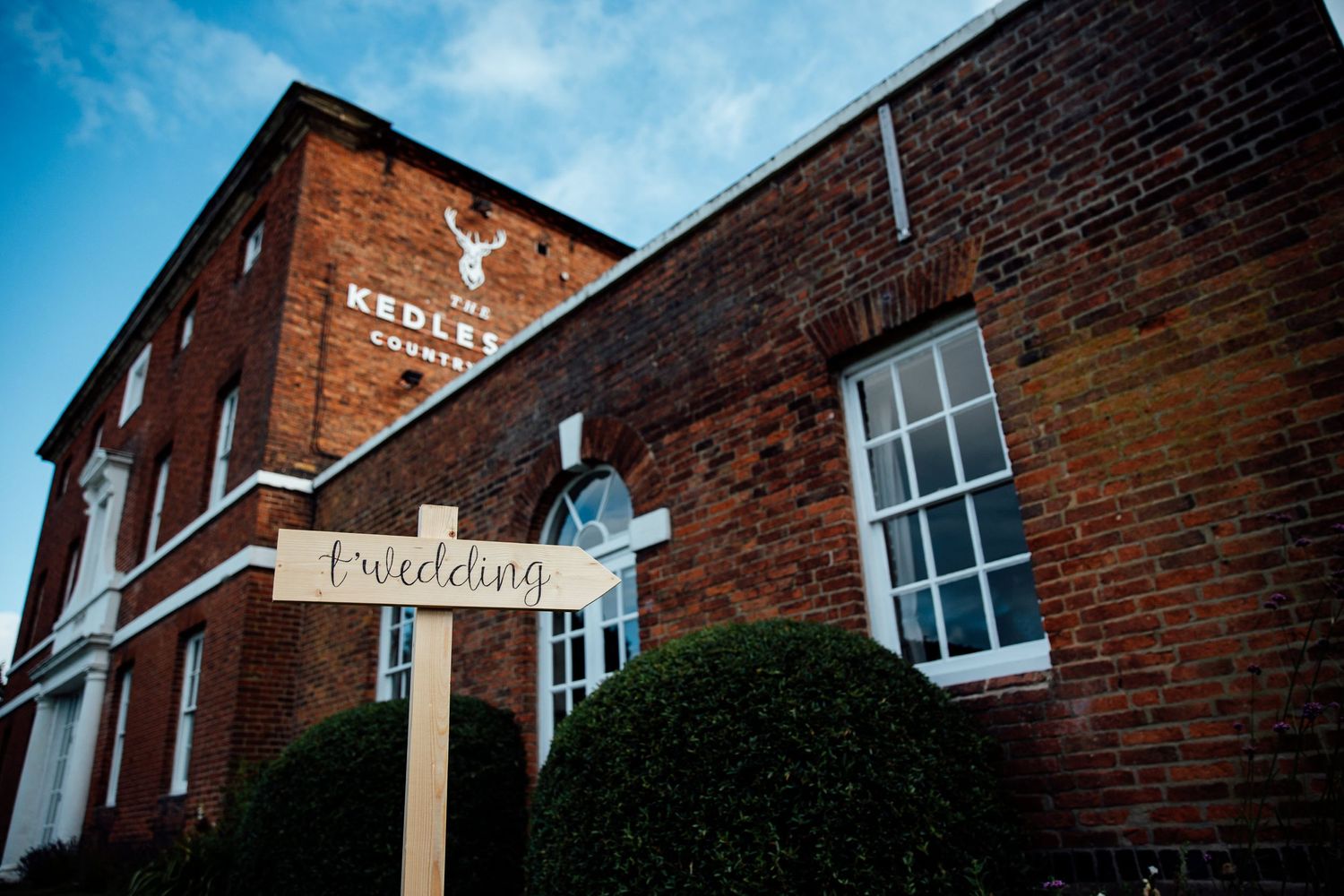 Exterior view of historic brick buildings against a blue sky.