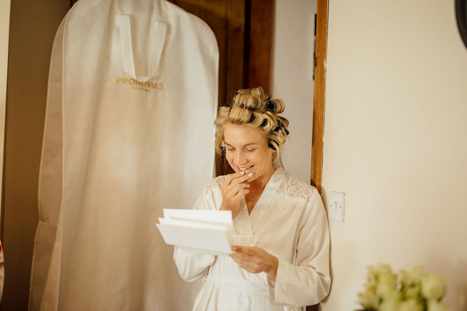 Getting ready scene with morning light streaming through window during wedding preparations.