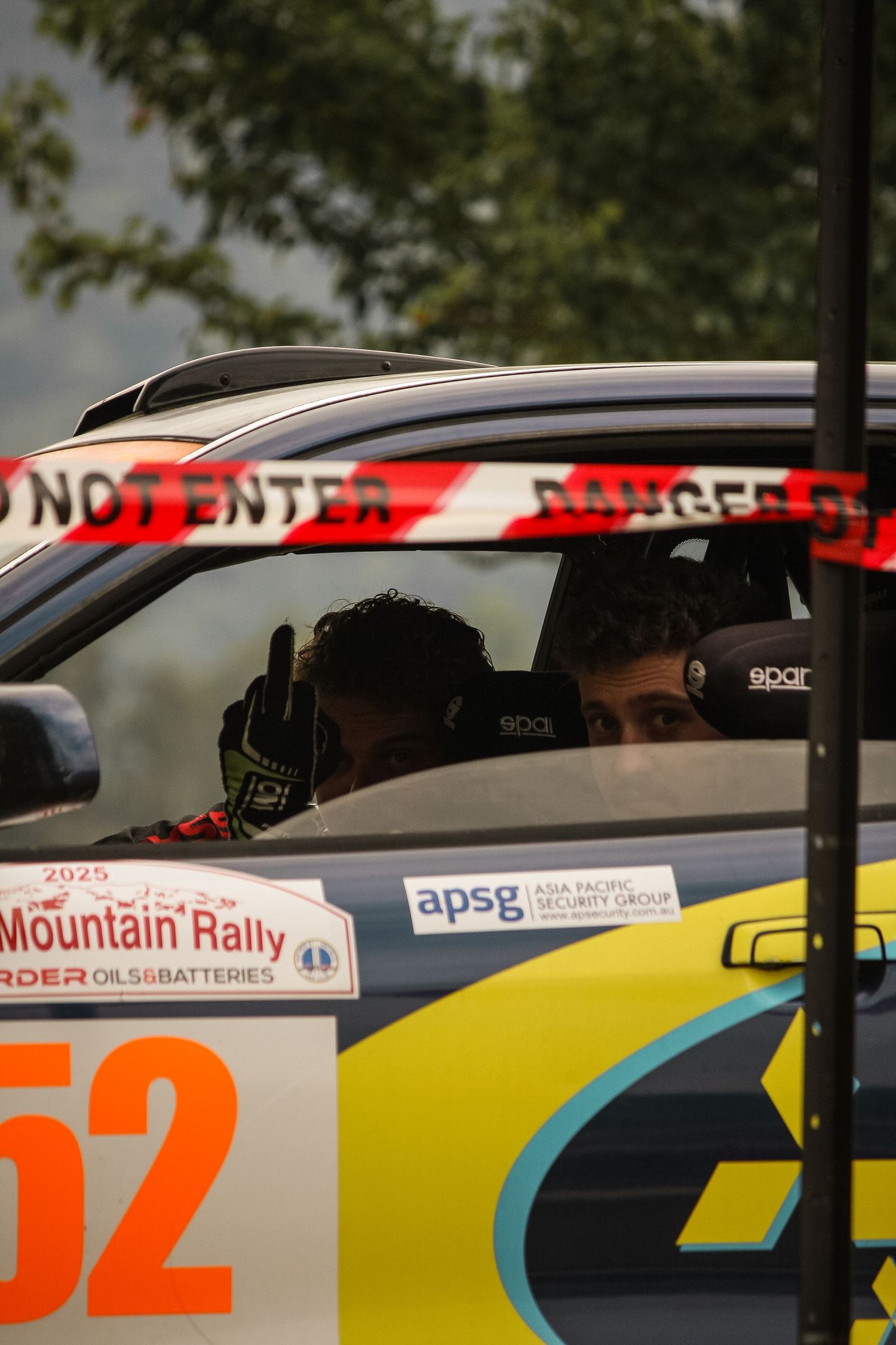 Rally cars lined up with racing numbers and sponsor decals visible.