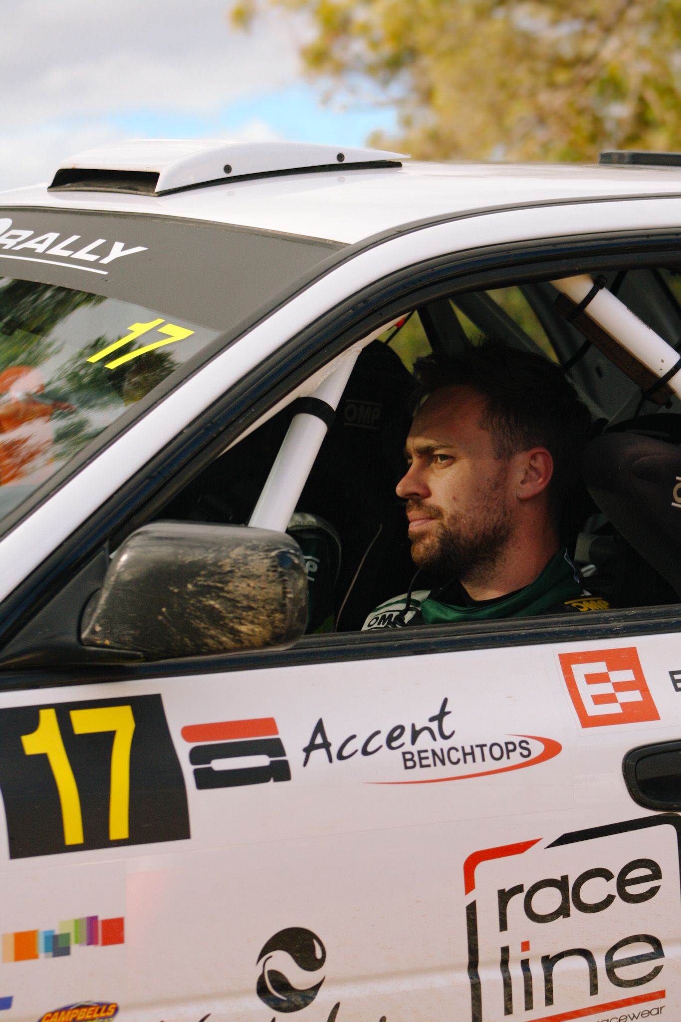 White rally car with racing number 17 and sponsor decals on the side.
