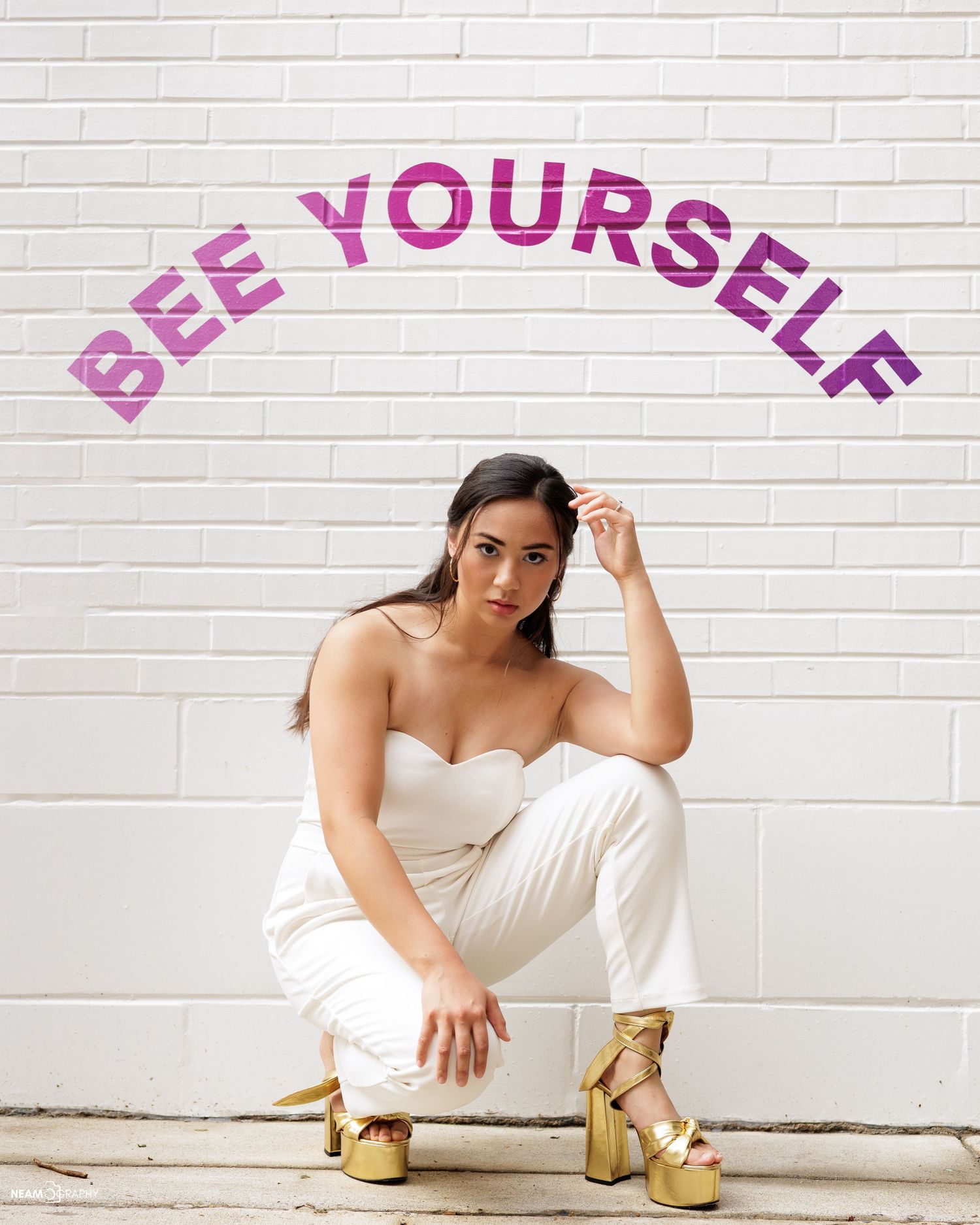 Lifestyle branding portrait in Rockville, MD, featuring a woman posing before a purple 