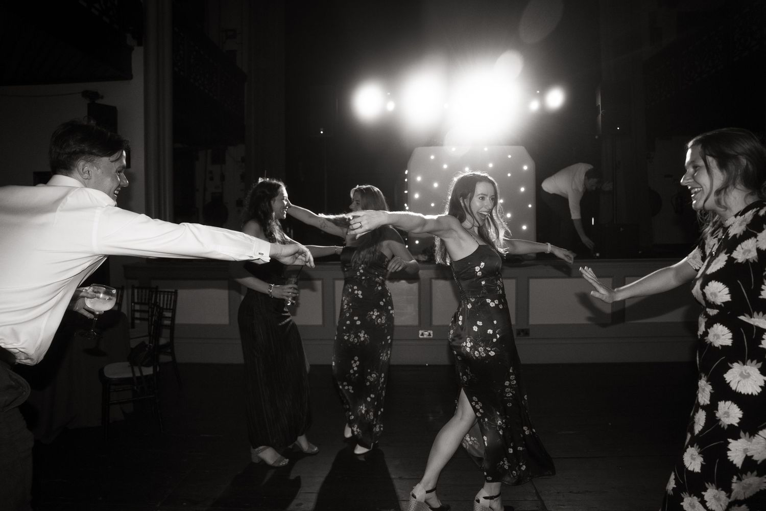 A punk rock band performs energetically on stage with dramatic lighting and movement during a live show performance.