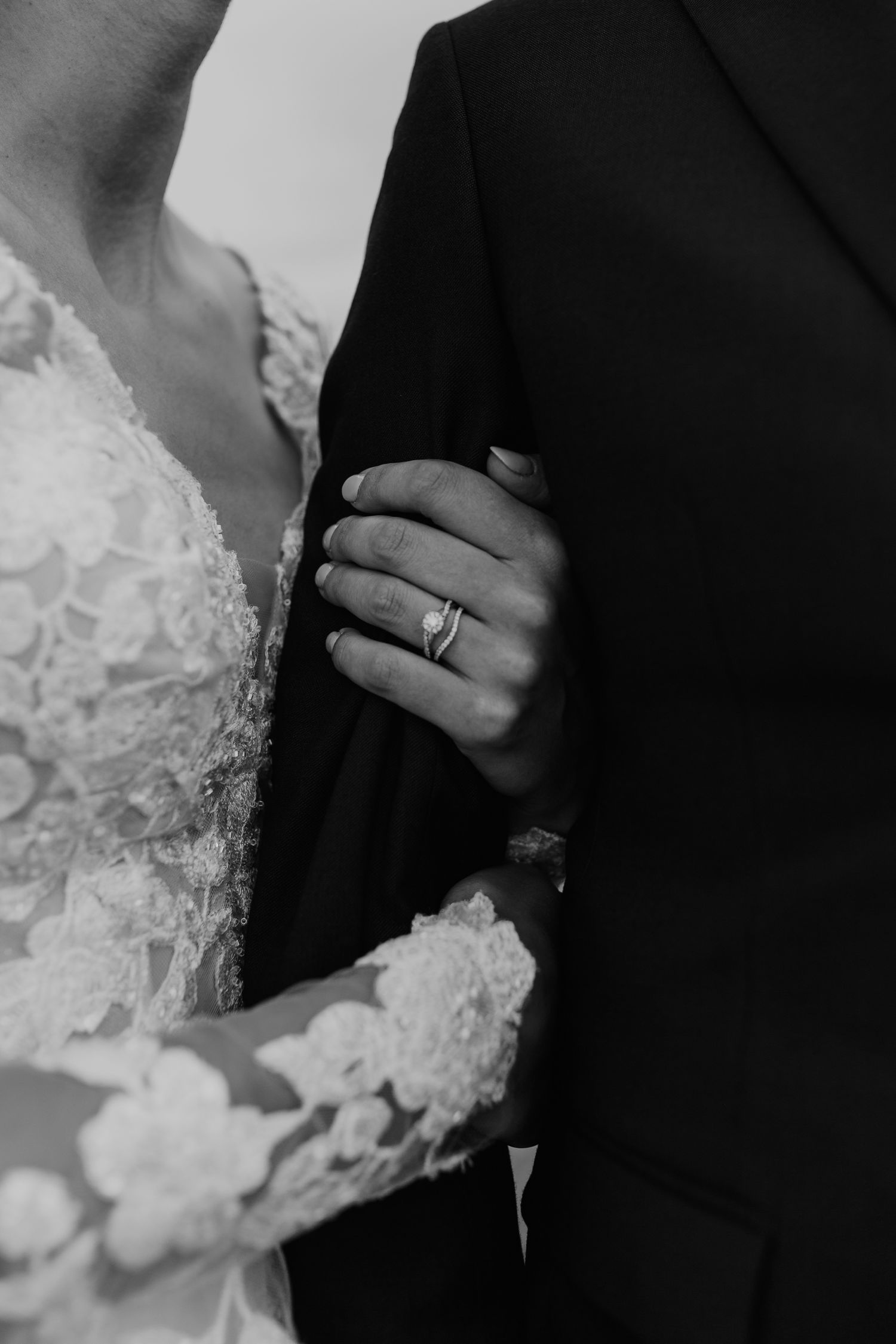 close up photo of a newly married couple, focus on bride's ring