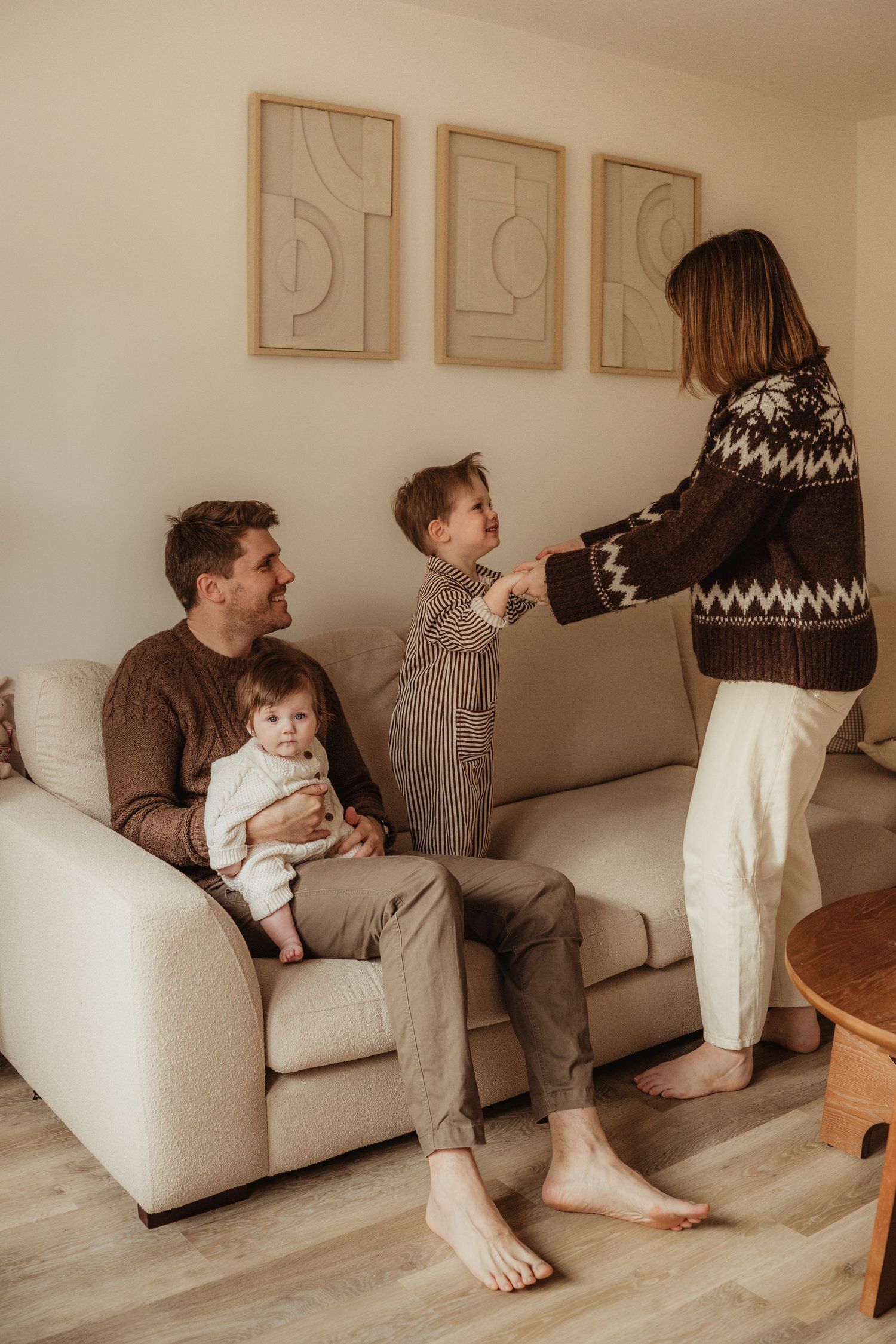 A sequence of photos showing playful interaction between family members on a beige couch in a minimalist living room.