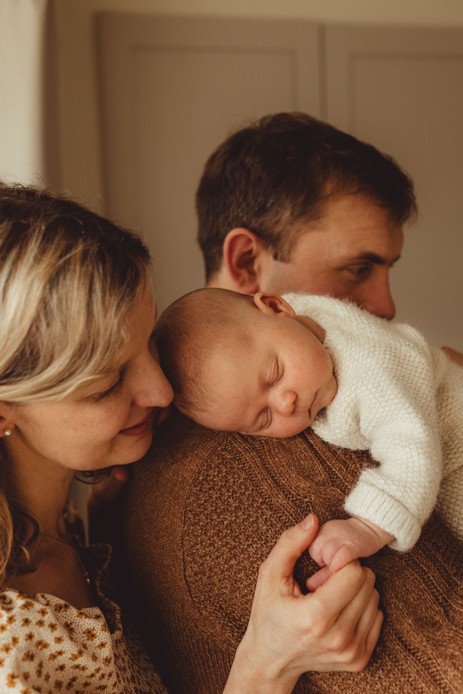 A series of intimate photos showing a couple sharing tender moments in warm indoor lighting.