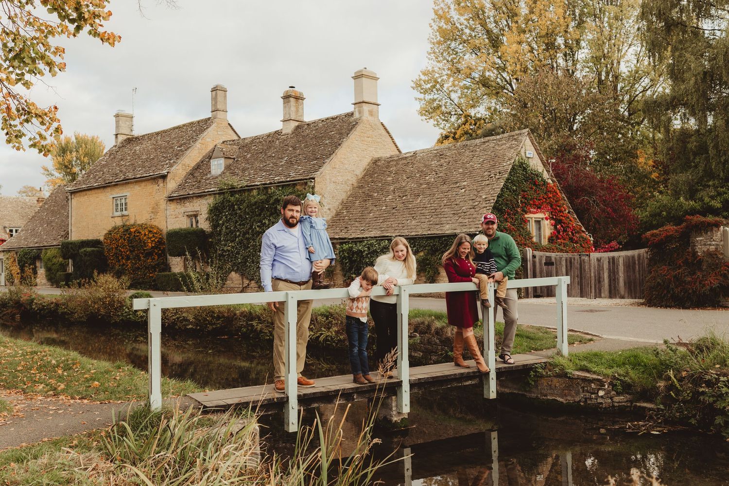 Couple enjoys a romantic sunset moment together on a wooden bridge in a rustic countryside setting.