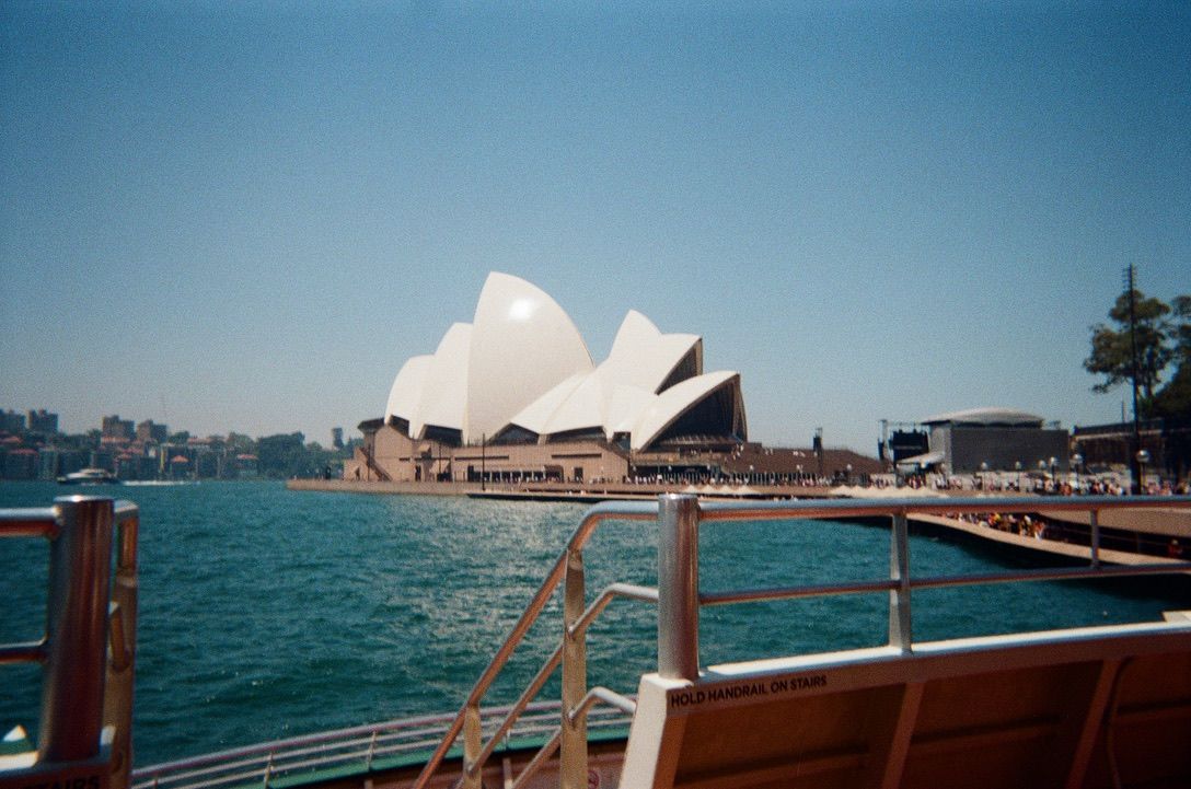 Sydney Opera House viewed from a ferry on Sydney Harbour, Australia, on a clear sunny day.