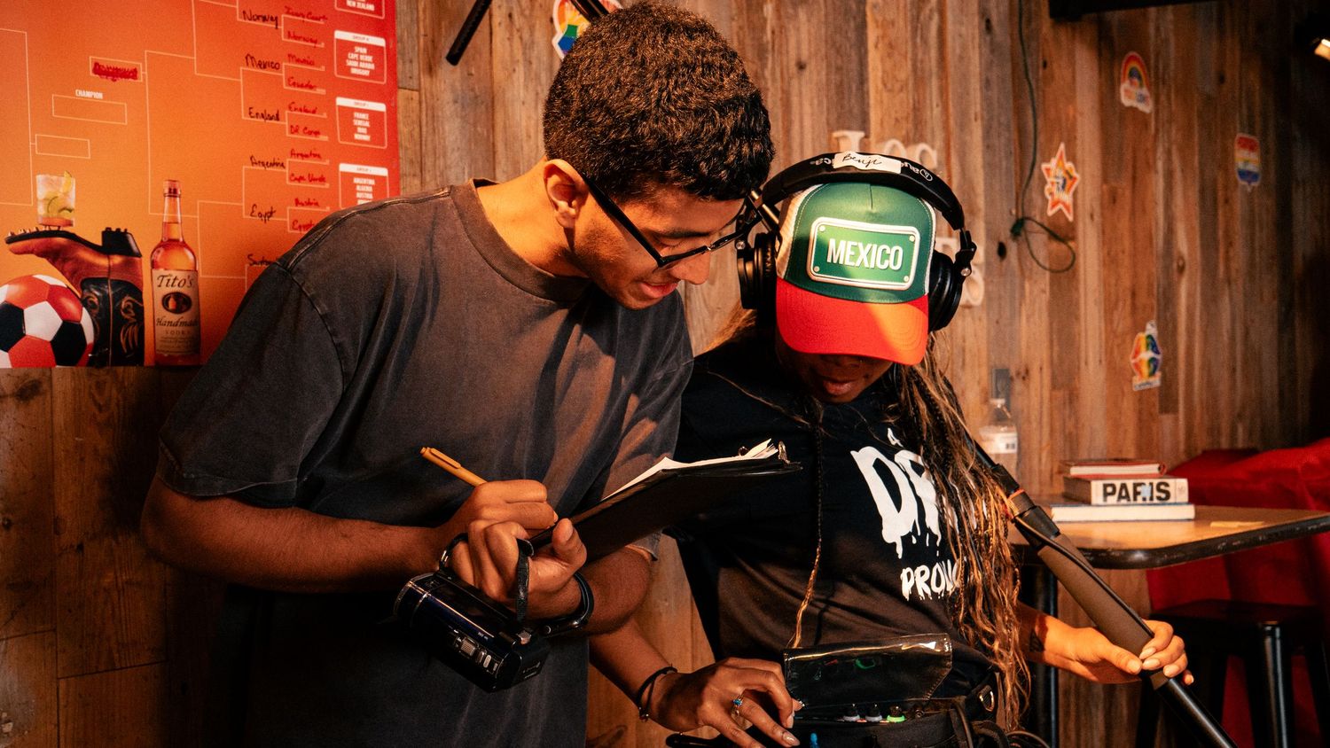 Two crew members review footage on a monitor during a film production shoot.