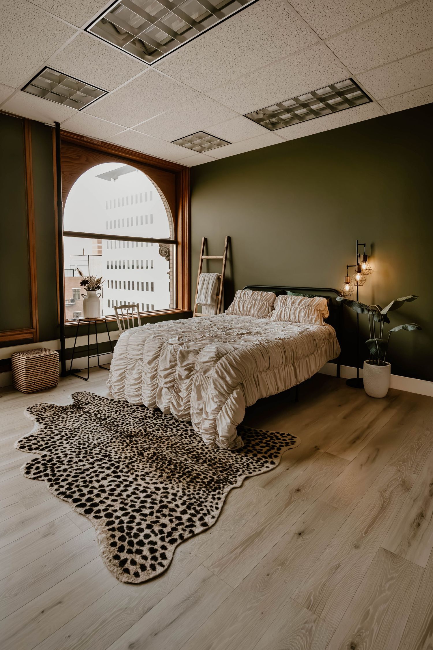 Moody photography studio interior with arched windows, curated furnishings, and natural light at Everwild Collective Studio in Spokane, WA