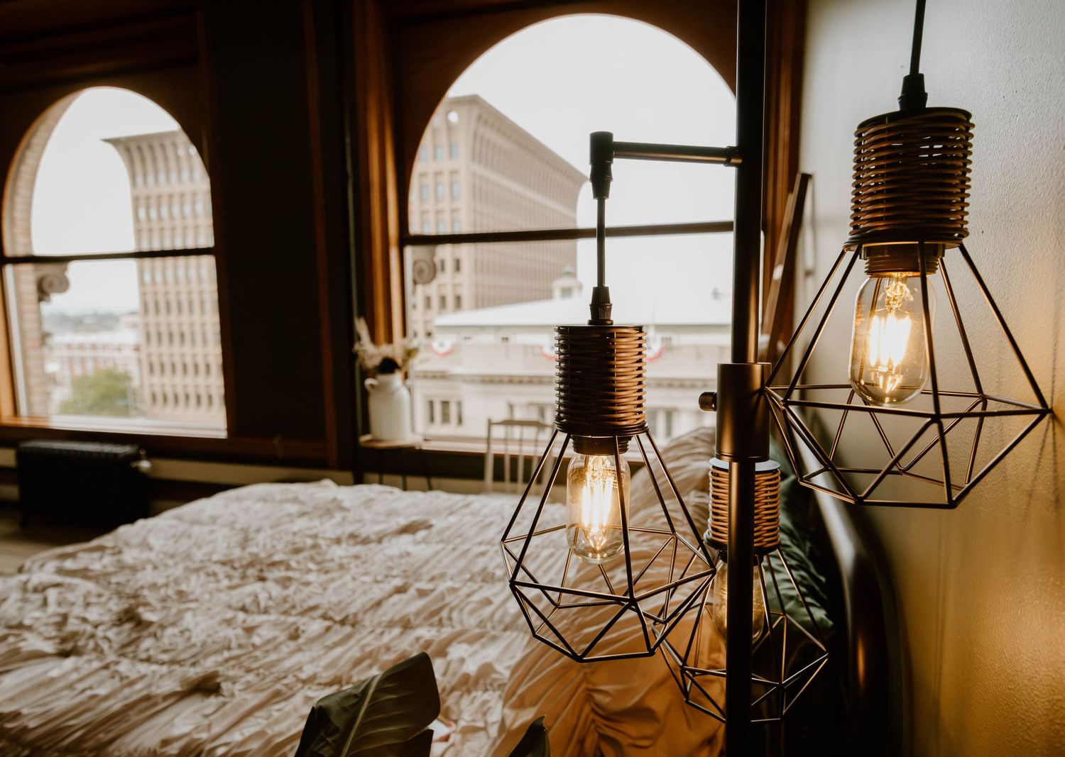 Moody studio interior with arched windows, natural light, and curated furnishings at Everwild Collective Studio in Spokane, Washington.