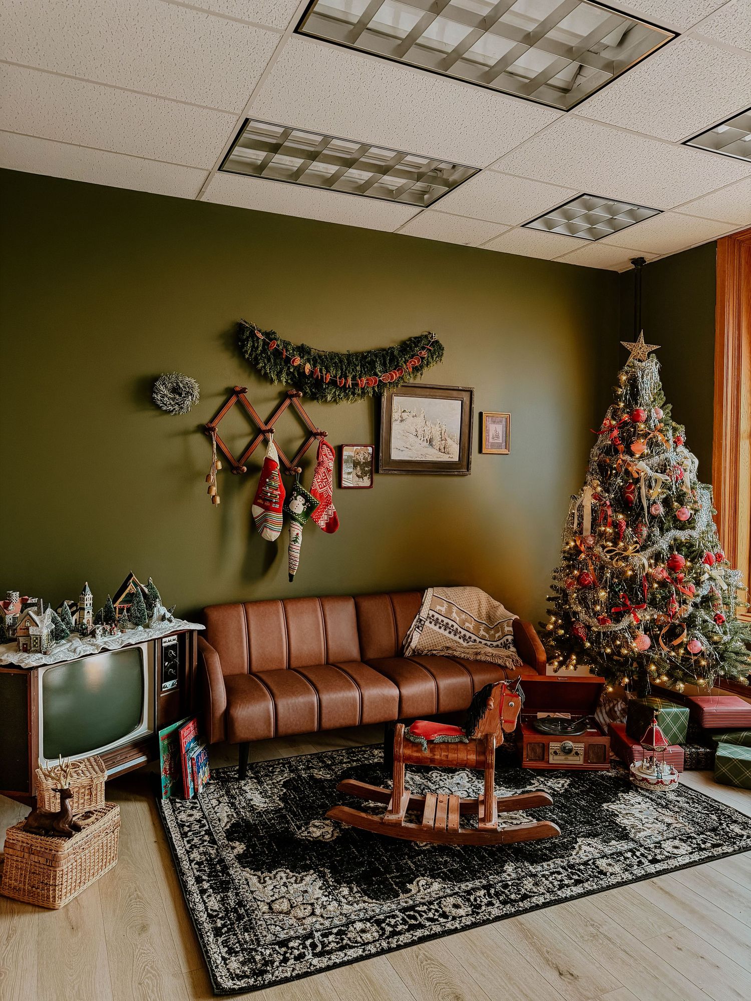 Festive Christmas living room photography setup with a decorated tree, vintage furniture, and holiday décor at Everwild in Spokane, WA.