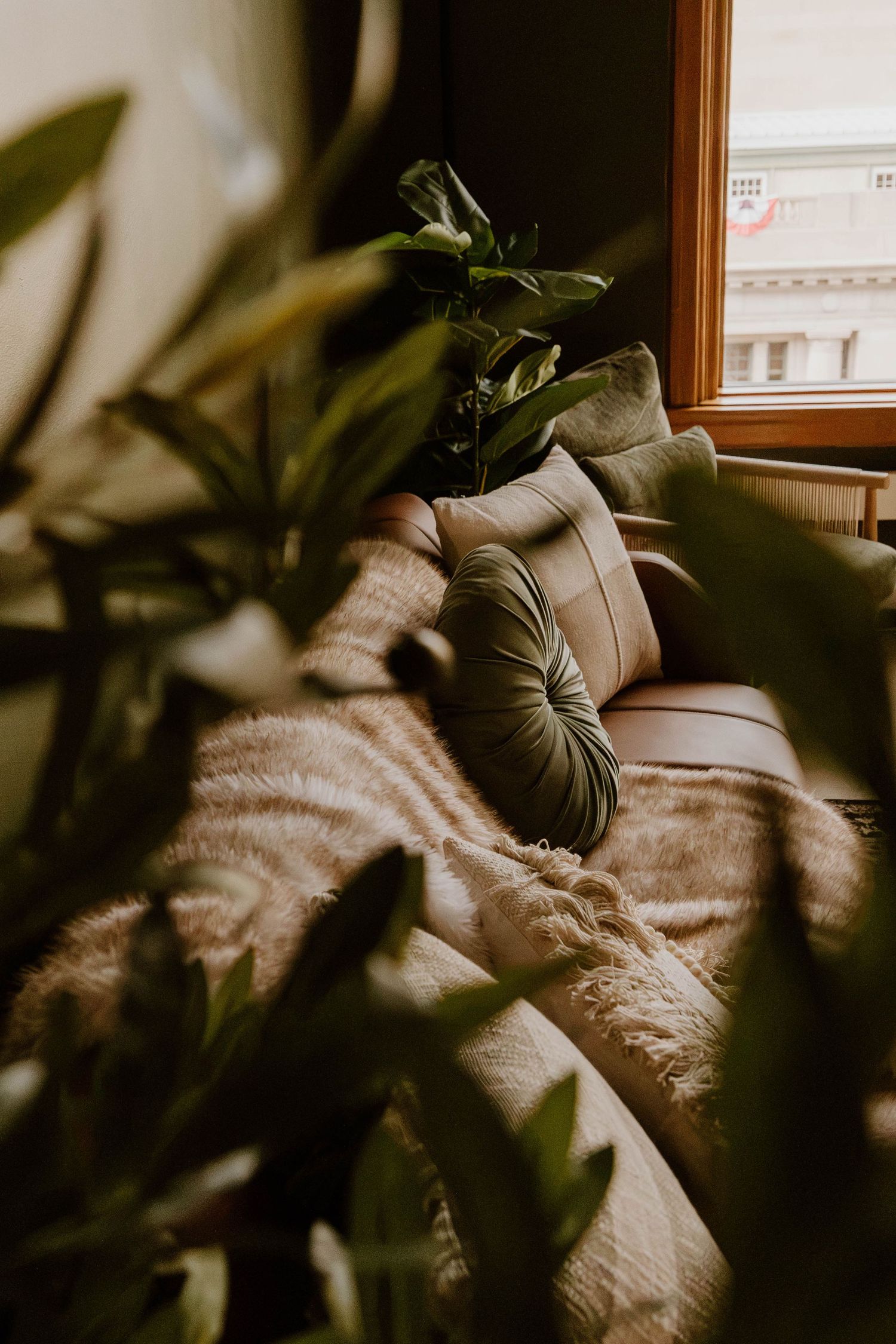 Cozy studio seating area surrounded by lush greenery and curated décor inside Everwild Collective Studio in Spokane, Washington.