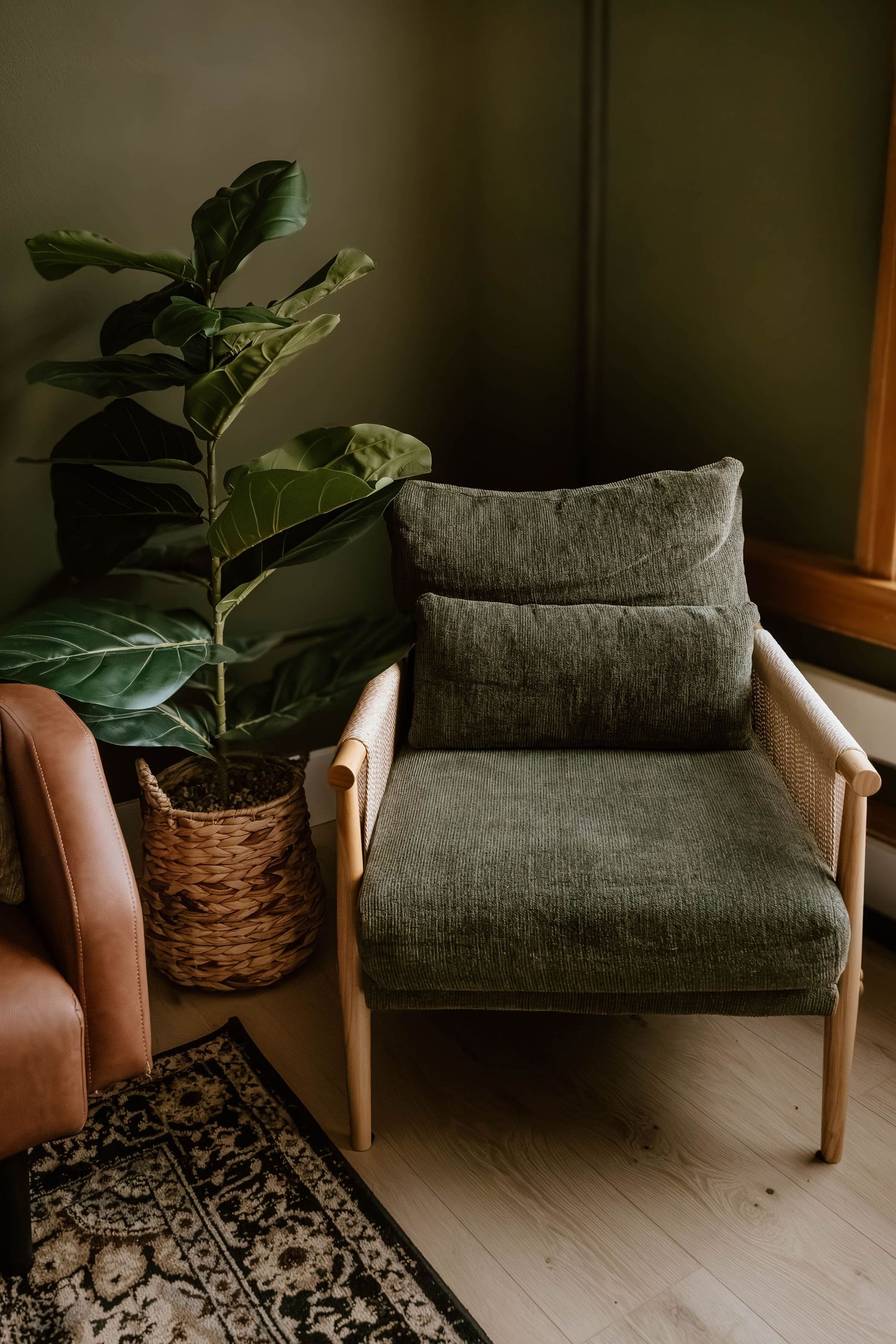 Curated accent chair and greenery creating a cozy photography setup inside Everwild Collective Studio in Spokane.