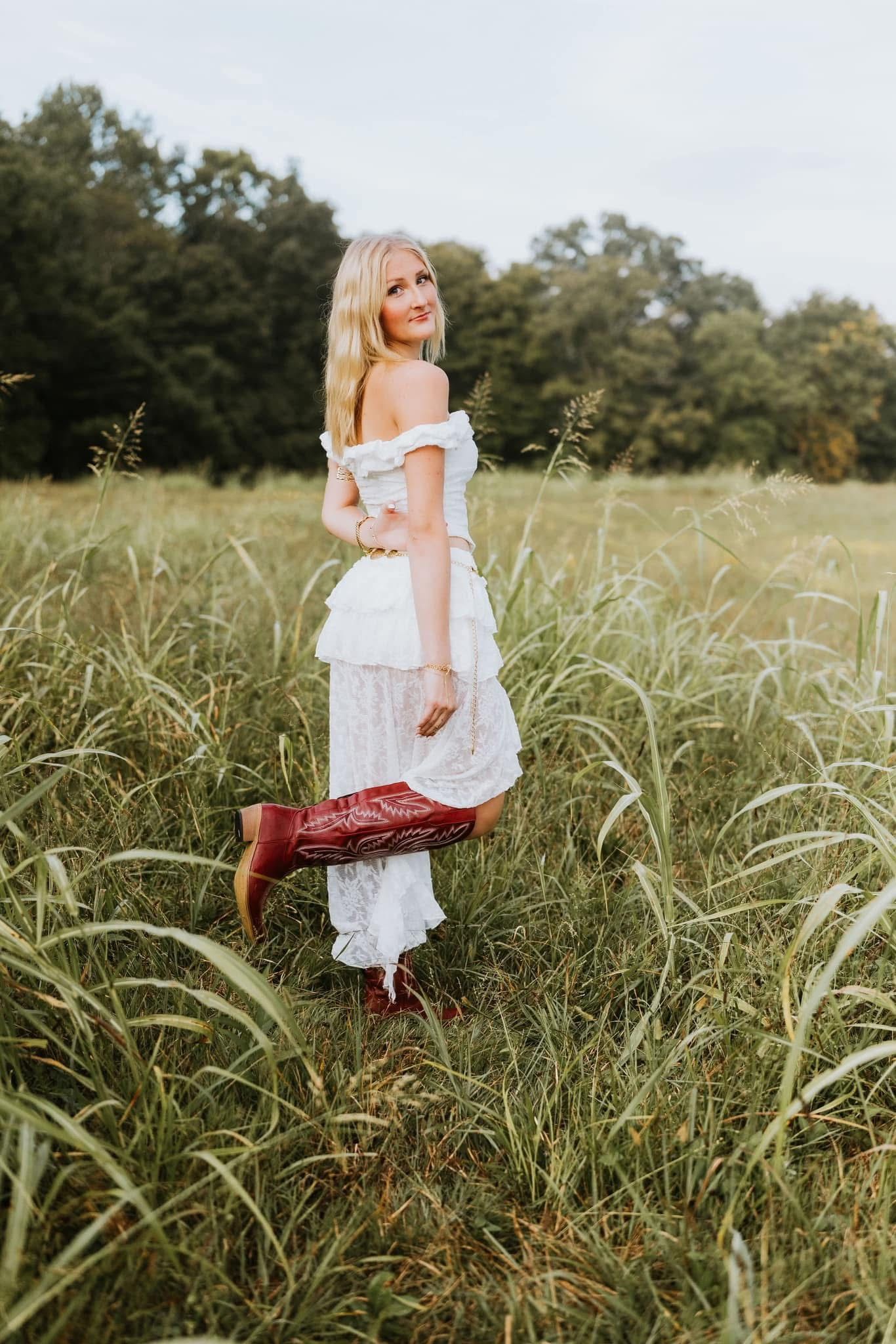 Senior session, red cowgirl boots with white dress, field