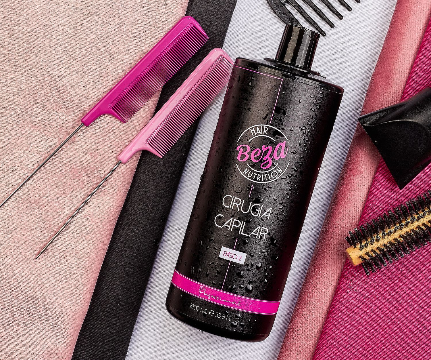 Beza Hair Nutrition Cirugia Capilar dark bottle with pink rat tail comb and brush on pink fabric background.