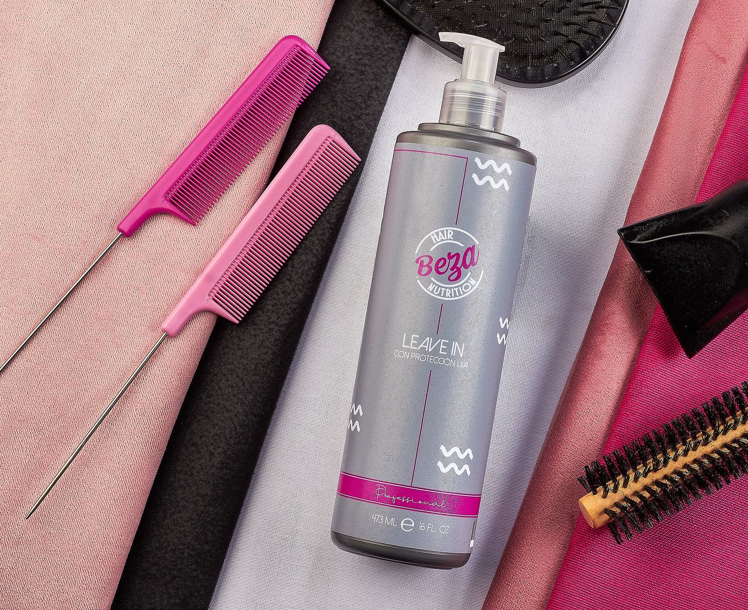 Beza Hair Nutrition Leave-In conditioner gray bottle displayed with pink metal comb on soft fabric background.