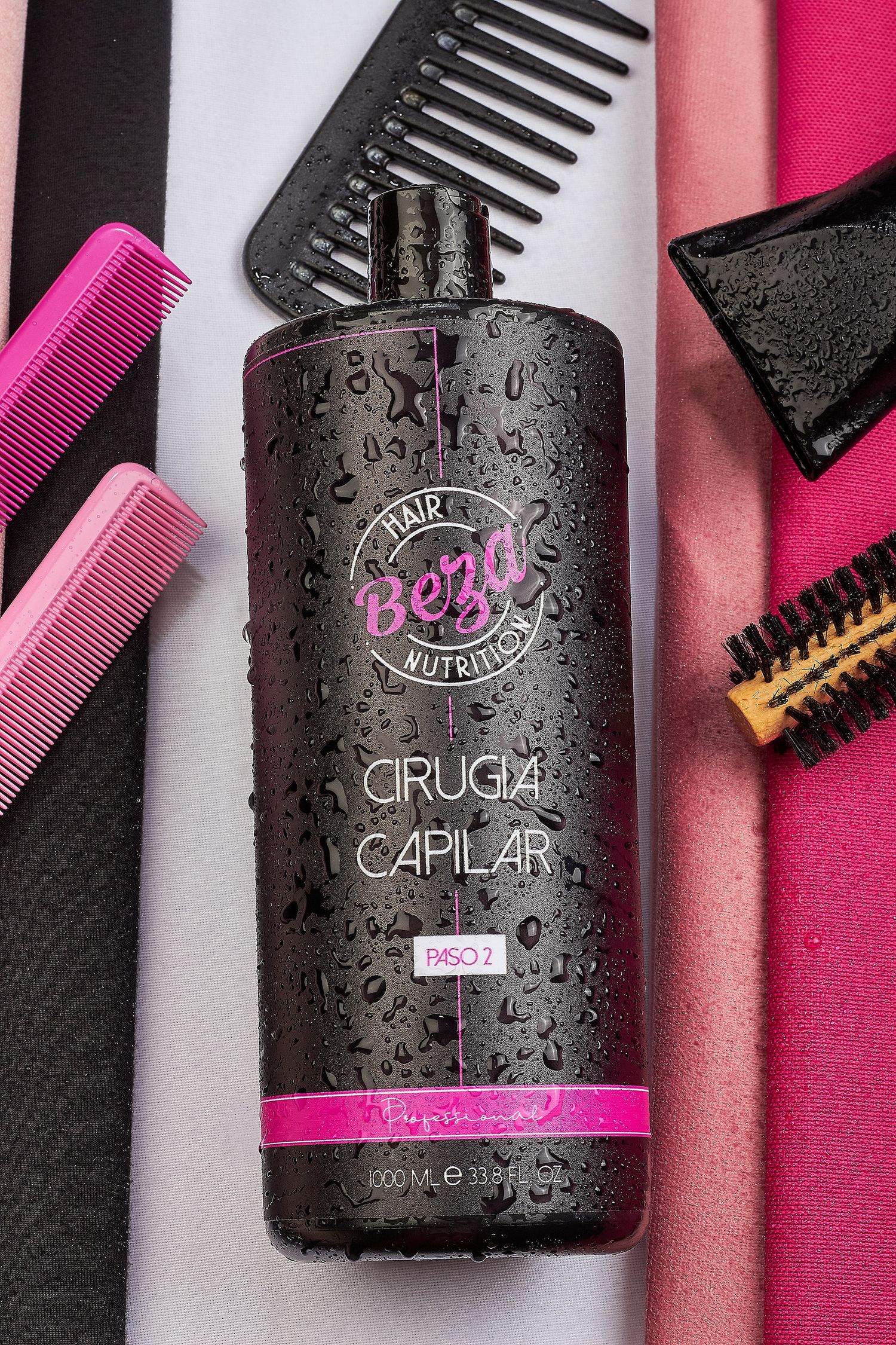 Beza Hair Nutrition Cirugia Capilar hair treatment bottle with water droplets, surrounded by pink and black combs.