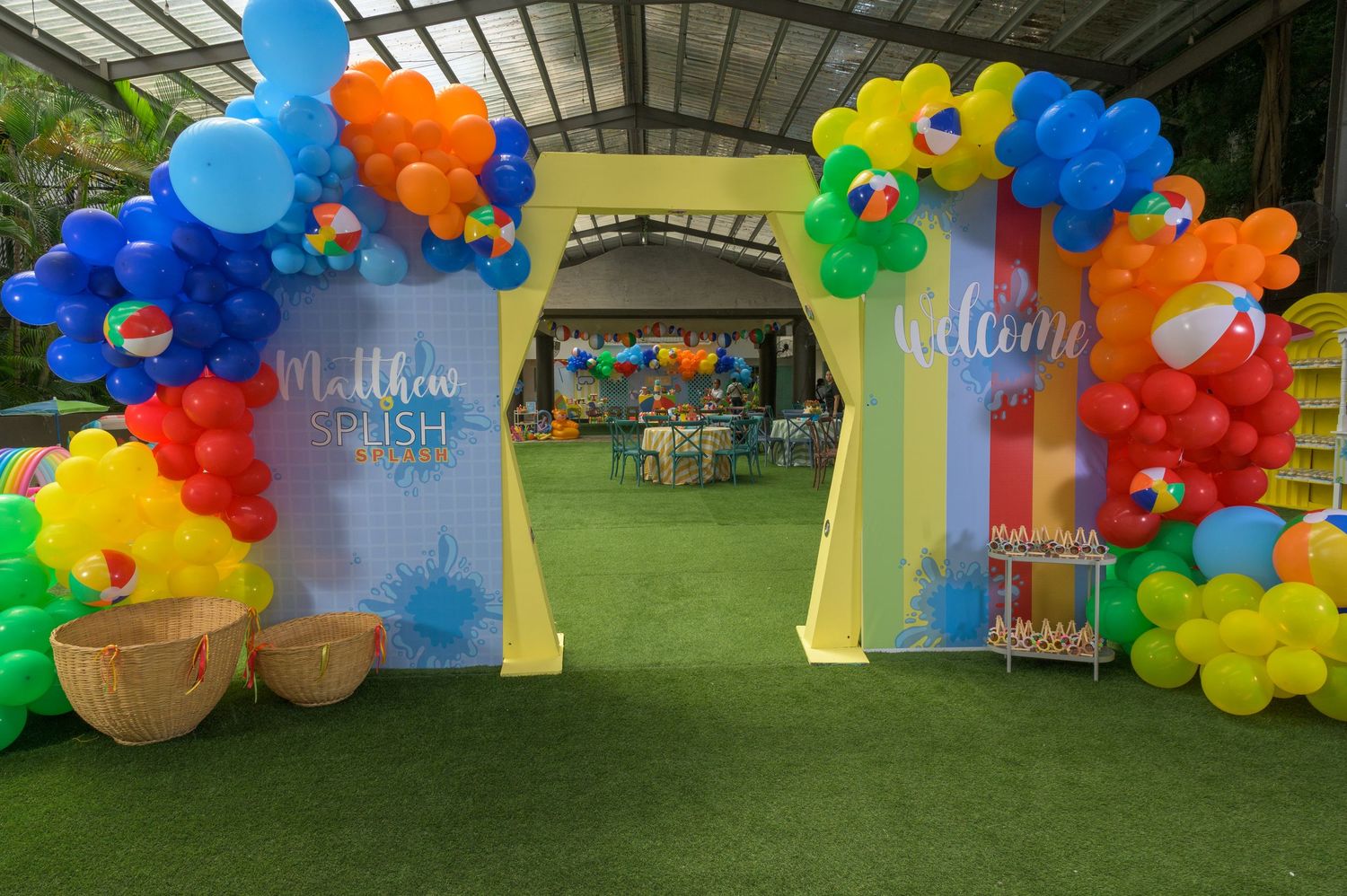 Welcome arch decorated with rainbow balloons at Matthews Pool Party birthday celebration entrance.