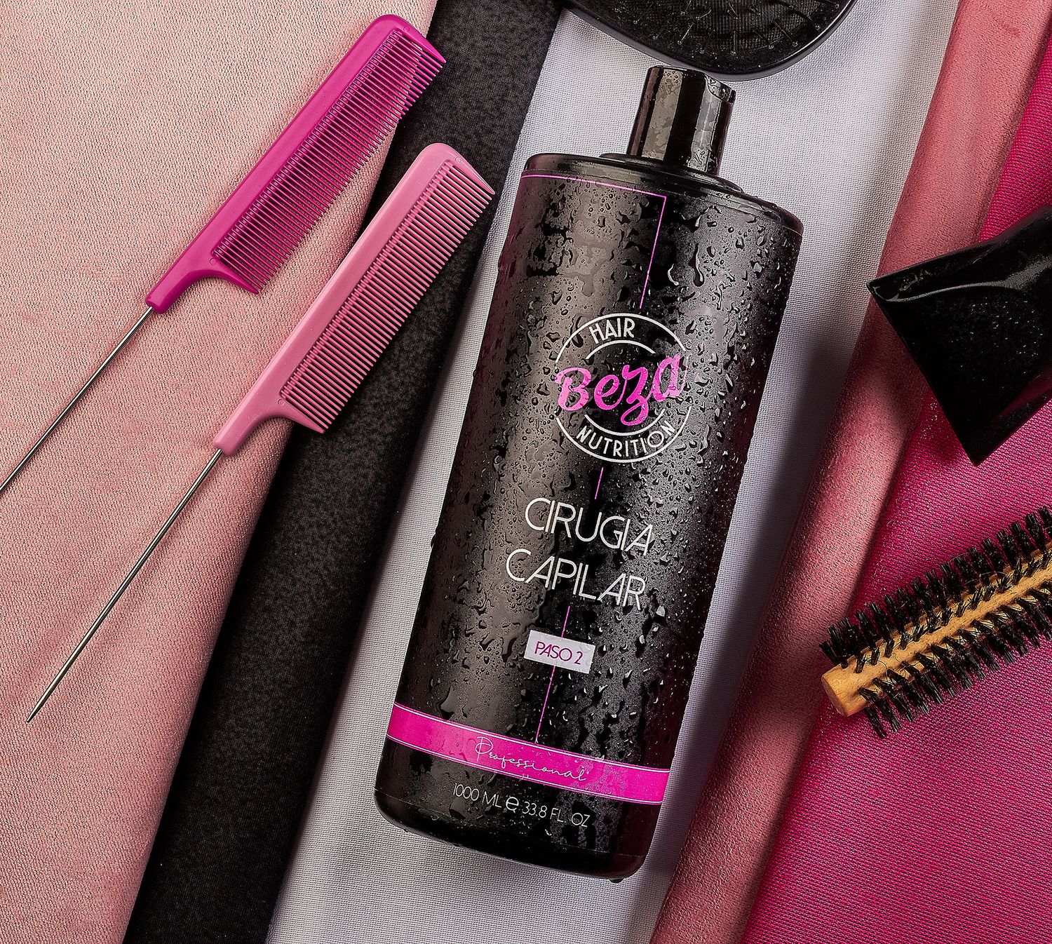 Beza Cirugia Capilar hair treatment bottle beside pink metal tail comb and round brush on pink background.