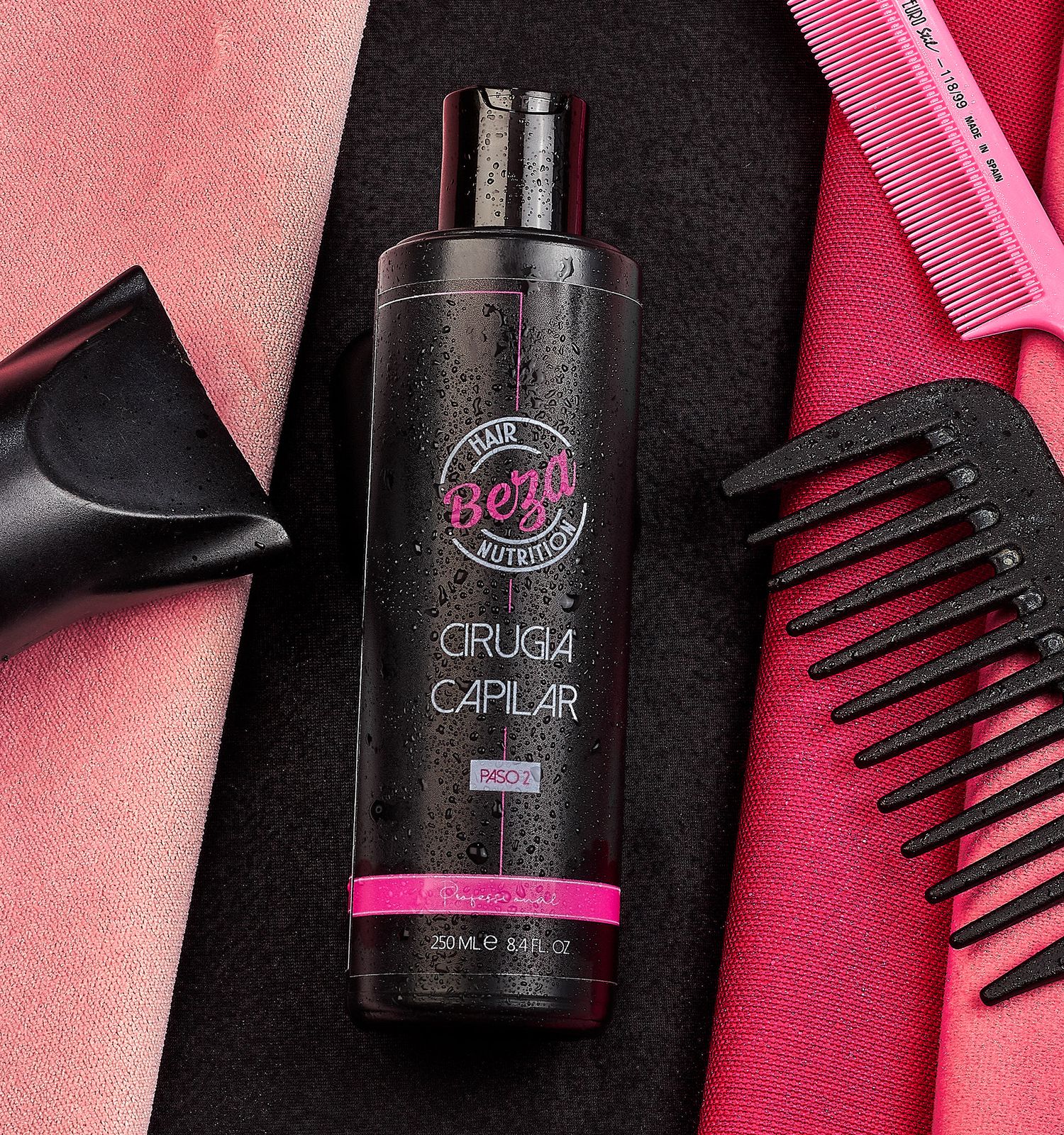 Beza Hair Nutrition Cirugia Capilar dark bottle surrounded by pink and black hair combs on dark background.