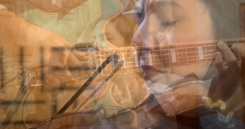 Close-up double exposure of musician playing acoustic guitar with focused expression.