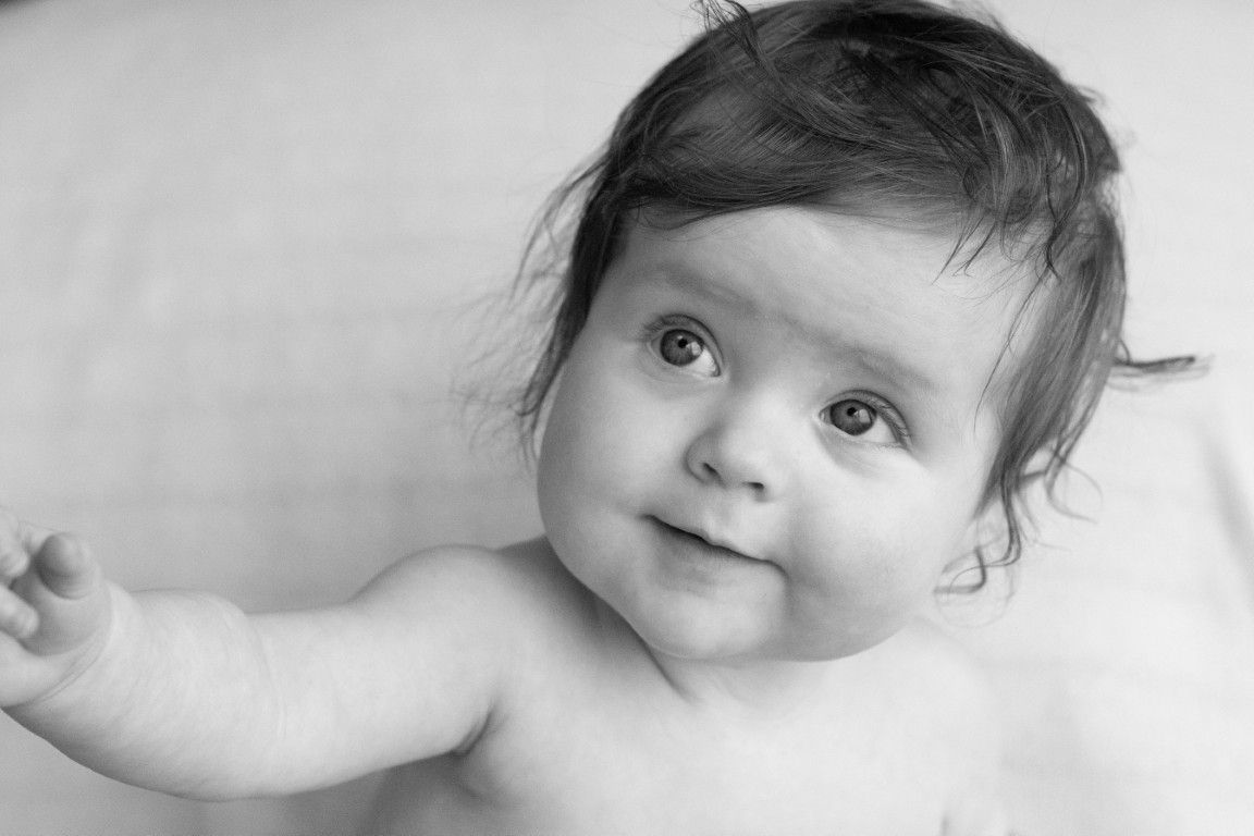 Black and white portrait of a toddler laughing in the Vale of Glamorgan