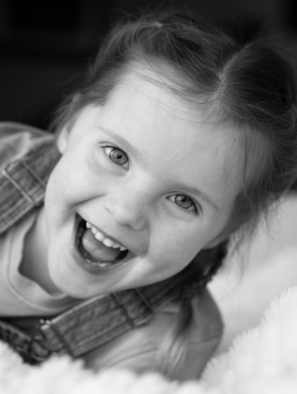 Black and white portrait of a toddler laughing in Abergavenny