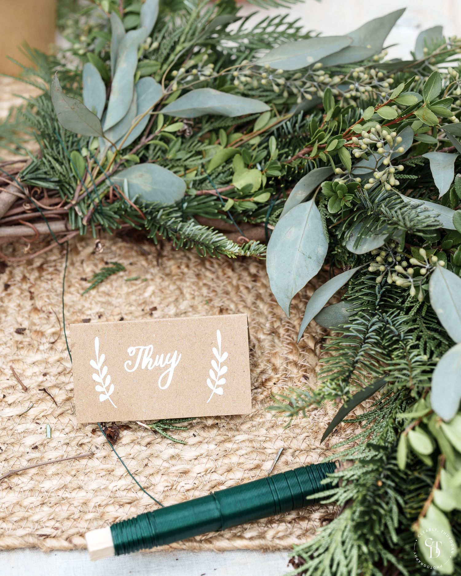 A name card in the middle of a wreath in progress. Name card reads 