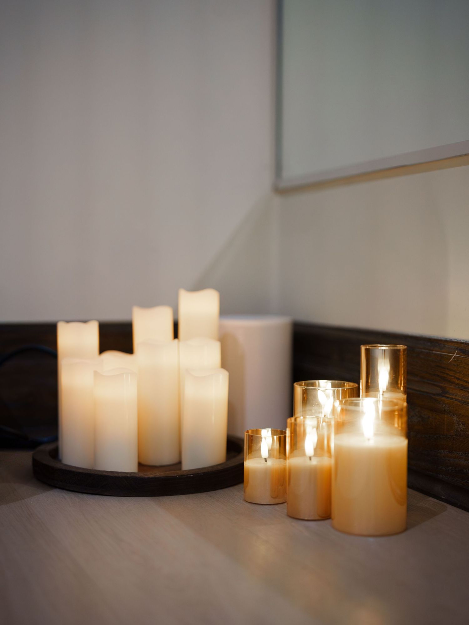 A warm corner of a pilates studio lit with a dozen fake candles.