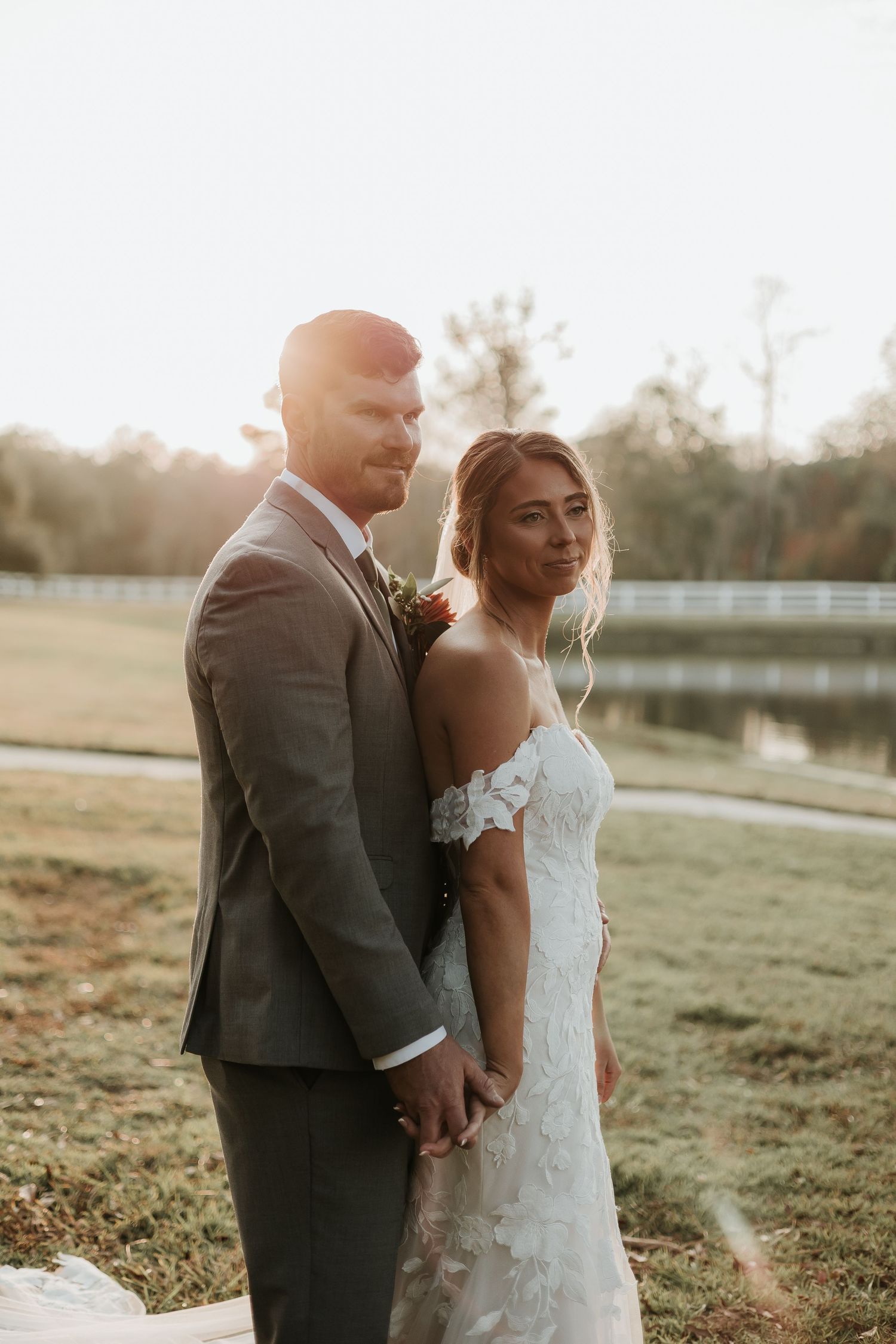 Romantic sunset wedding portraits in a rustic outdoor setting.