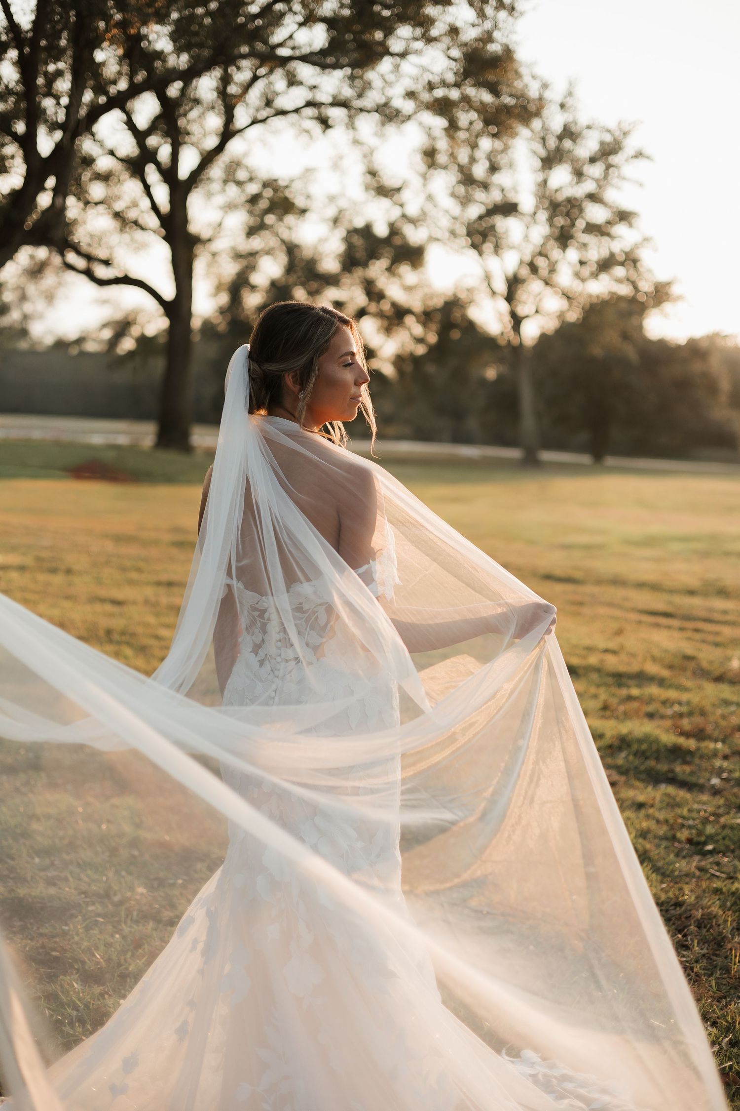 Dreamy bridal portraits with flowing veil in golden sunset light.
