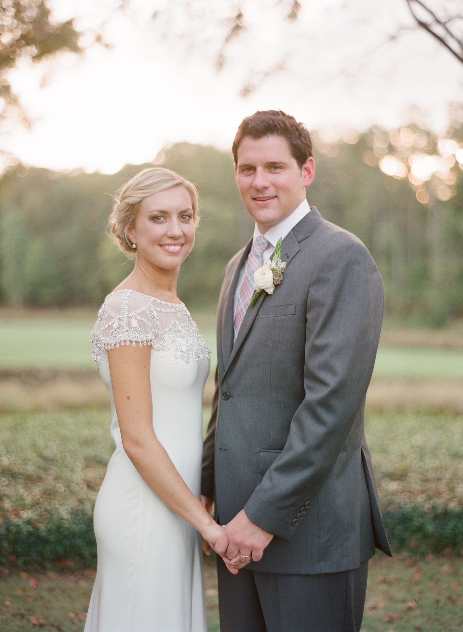 Outdoor wedding portraits of couple in formal attire during golden hour.