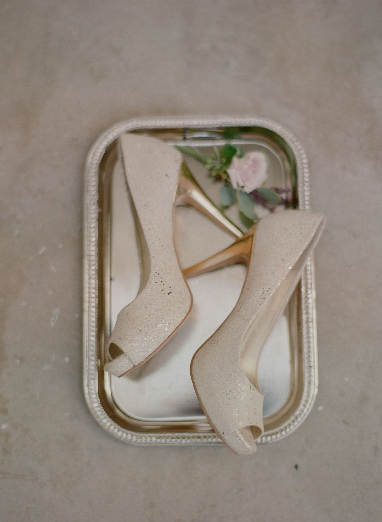 Decorative white paper cutouts arranged on a vintage tray.
