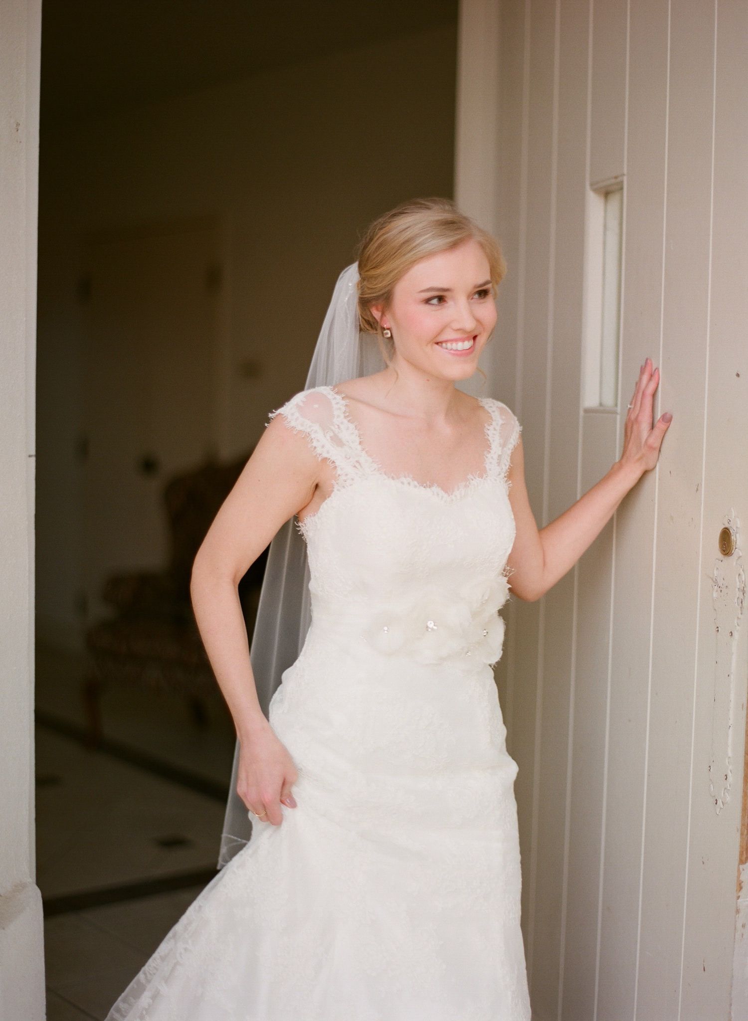 A sequence showing someone in a white wedding dress moving playfully through a light interior space.