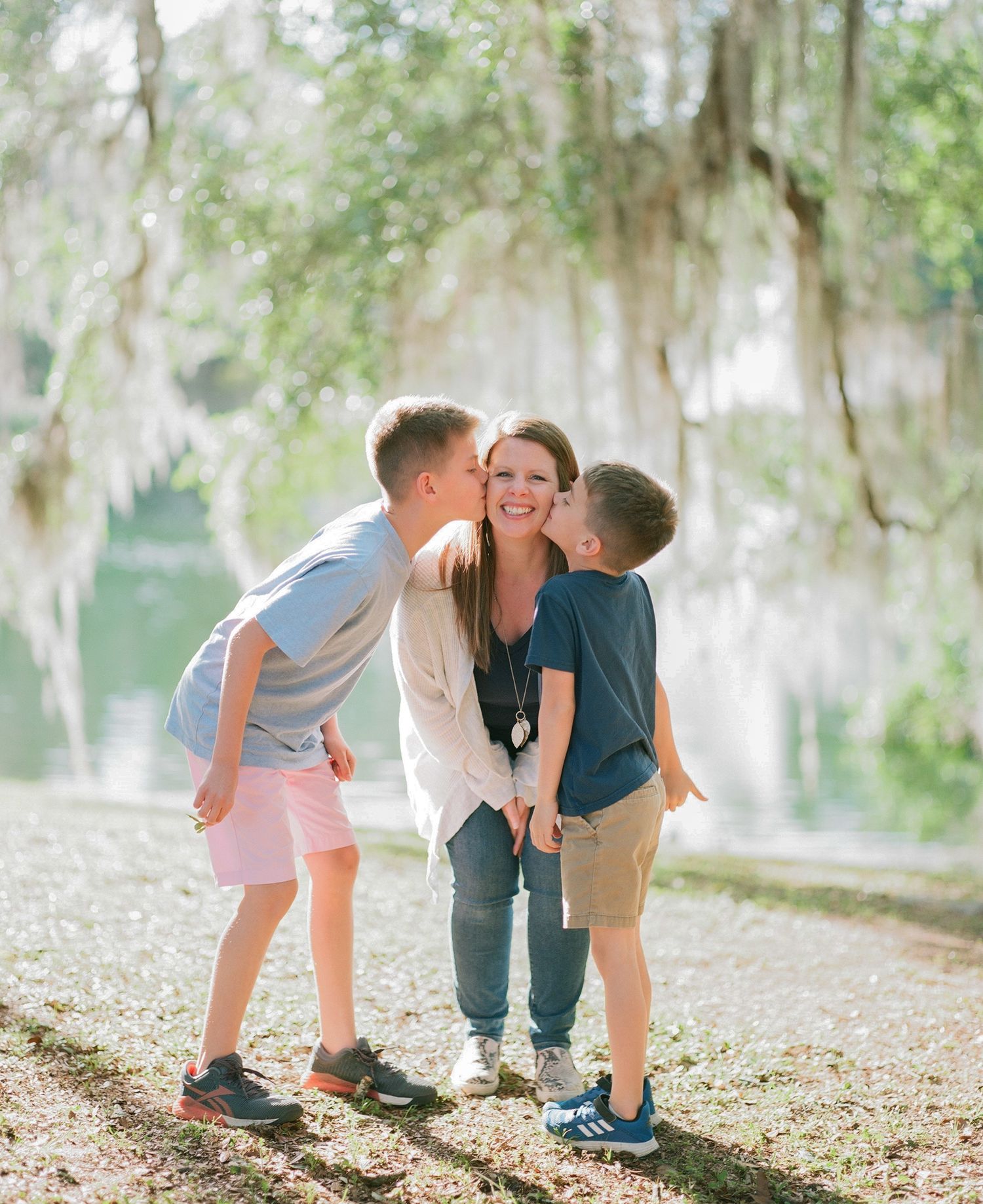 Three candid film photos showing playful moments shared in a lush outdoor setting with Spanish moss trees — Huntsville, Alabama film photogr