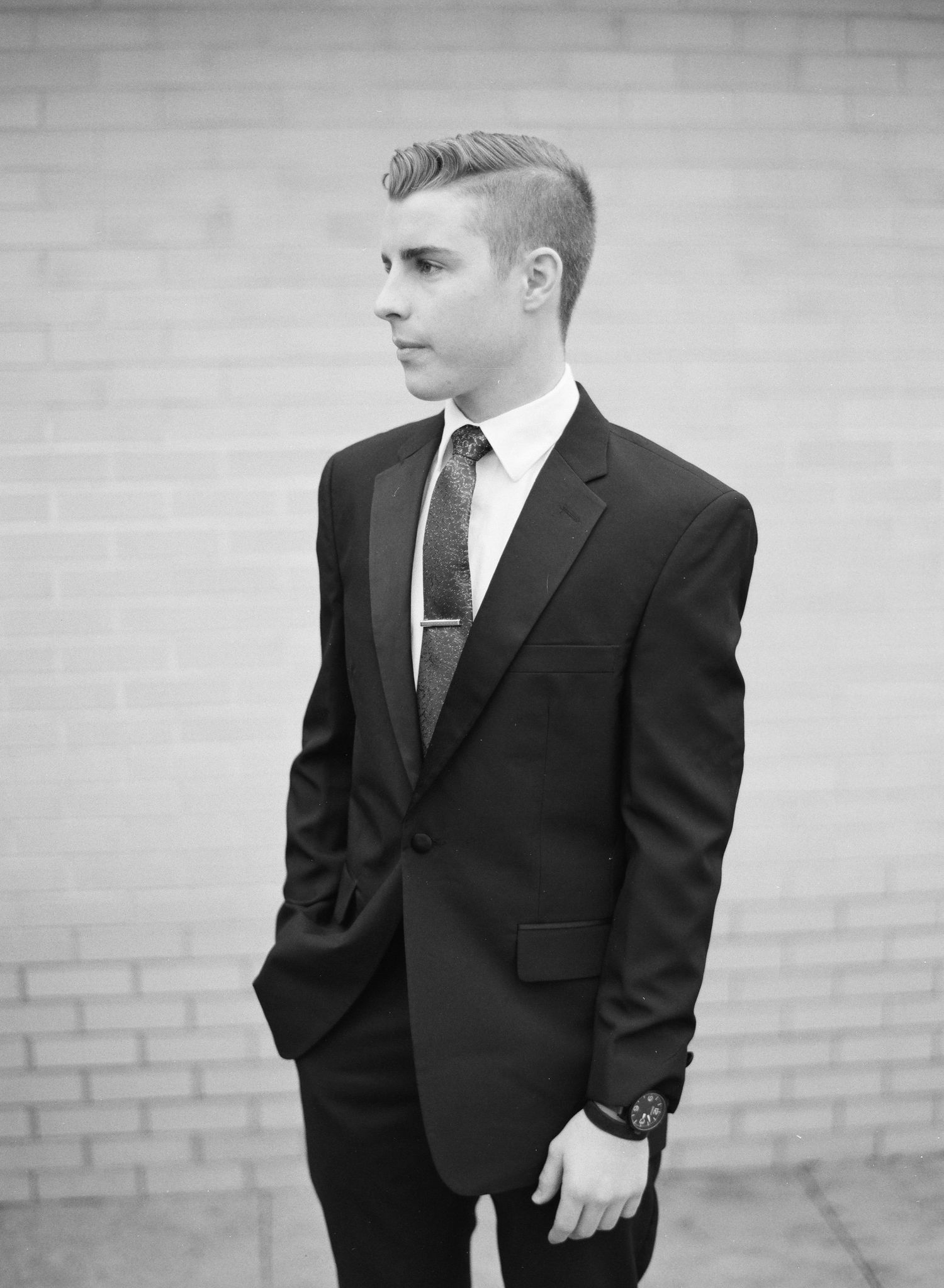 Black and white photo of young boys in formal suits.