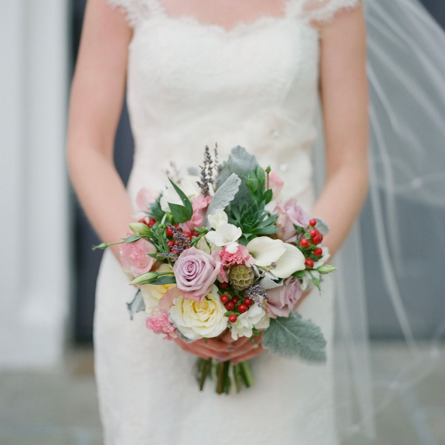 Elegant bridal bouquet with pink roses, succulents and mixed flowers.